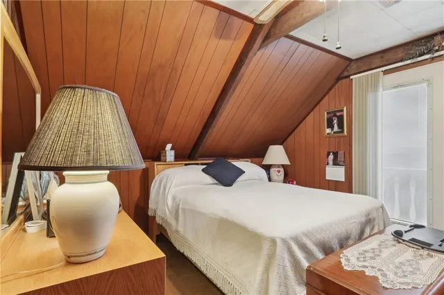 a bedroom with two beds and a chair