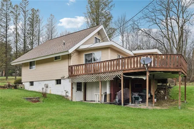 a view of a house with a yard and sitting area