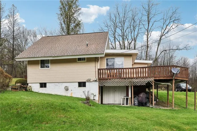 a view of a house with a yard and deck