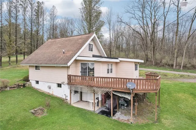 a view of a house with a yard deck and furniture