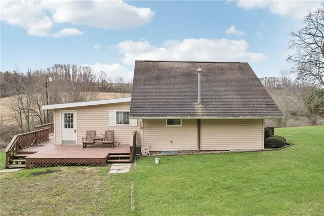 a view of a backyard with table and chairs and potted plants