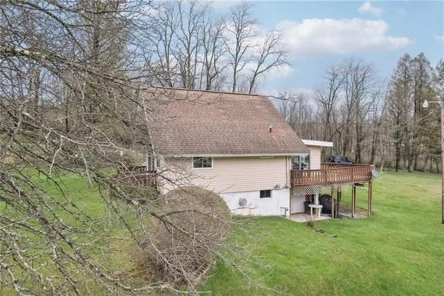 a view of a house with a yard and sitting area