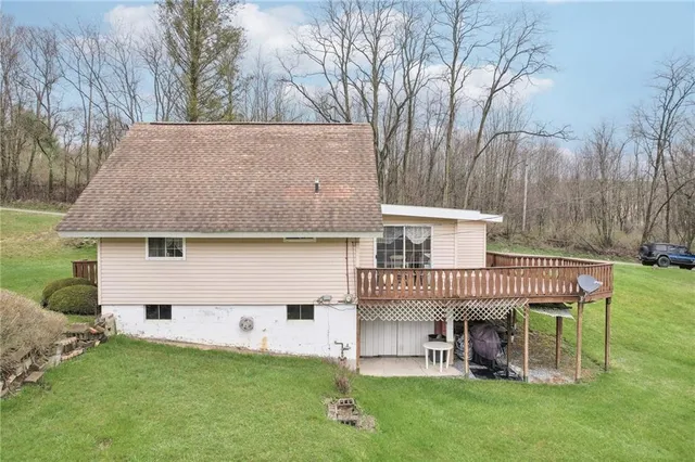 a view of a house with a yard chairs and table and chairs