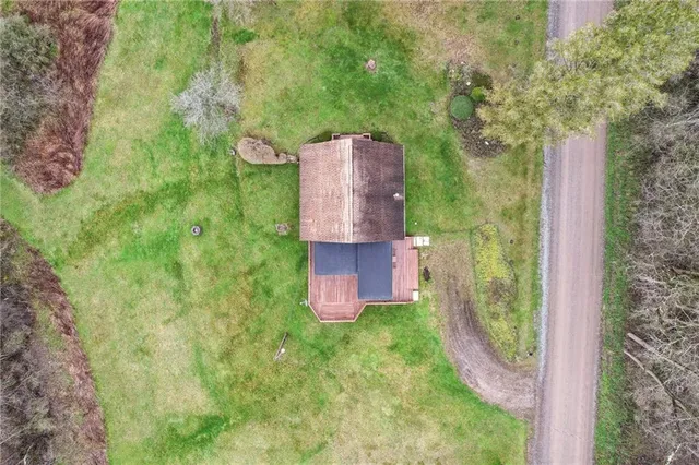 an aerial view of a house with a yard