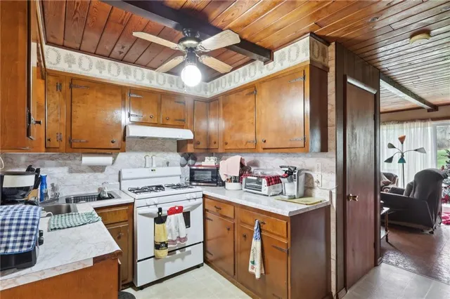 a kitchen with a refrigerator a stove top oven a sink and dishwasher