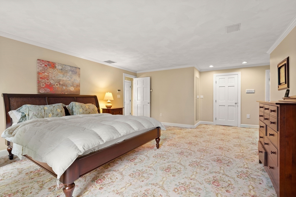 37 Old Planters Road Beverly, MA 01915 - Photo 24 of 42 a spacious bedroom with a bed and a couch