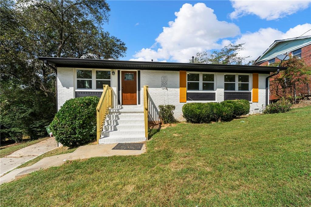 a front view of a house with garden and porch