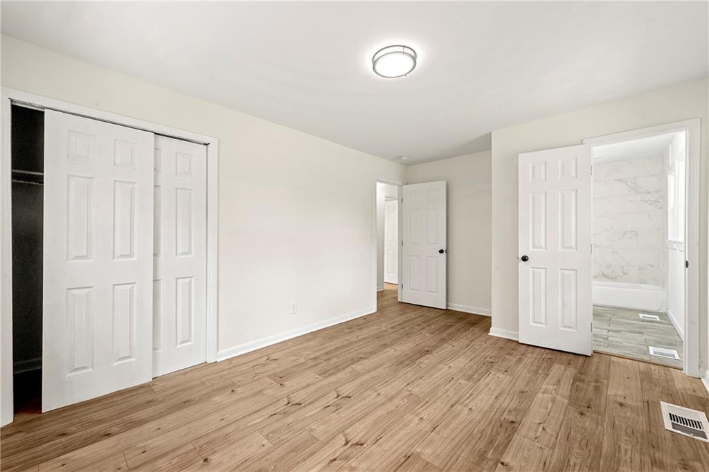 3981 Rutgers Drive Southwest Atlanta, GA 30331 - Photo 8 of 13 an empty room with wooden floor and windows