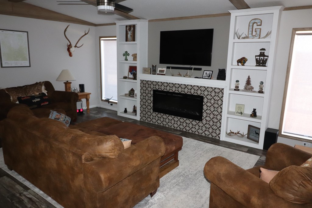 20120 Other Rocksprings, TX 78880 - Photo 12 of 22 a living room with furniture a flat screen tv and a fireplace