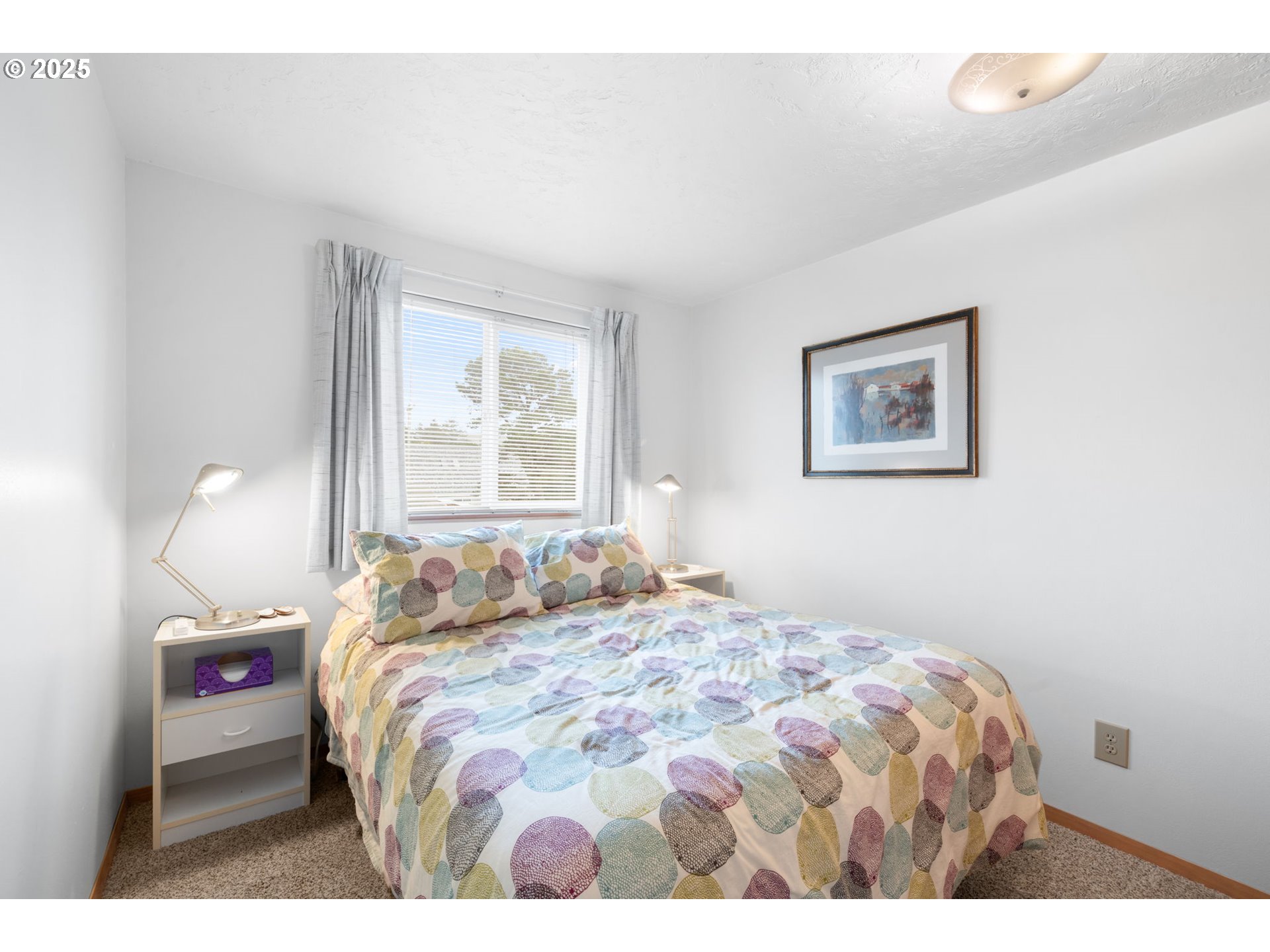 337 16th Avenue Seaside, OR 97138 - Photo 12 of 38 a bedroom with a bed and a painting on the wall