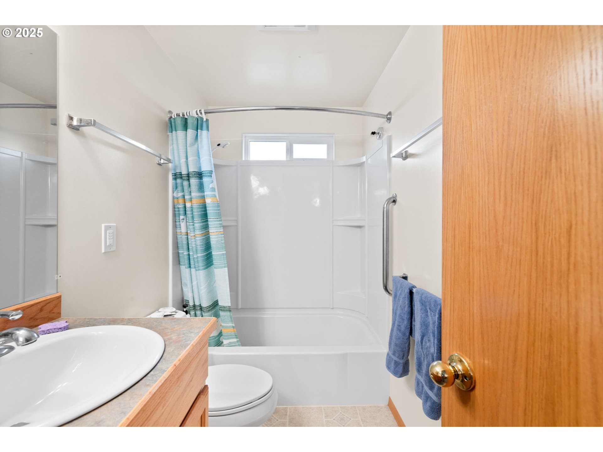 337 16th Avenue Seaside, OR 97138 - Photo 16 of 38 a bathroom with a sink a toilet a mirror and shower