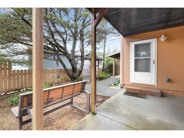 a backyard of a house with table and chairs