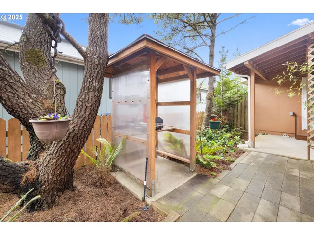 a kitchen with granite countertop a sink a stove and wooden cabinets