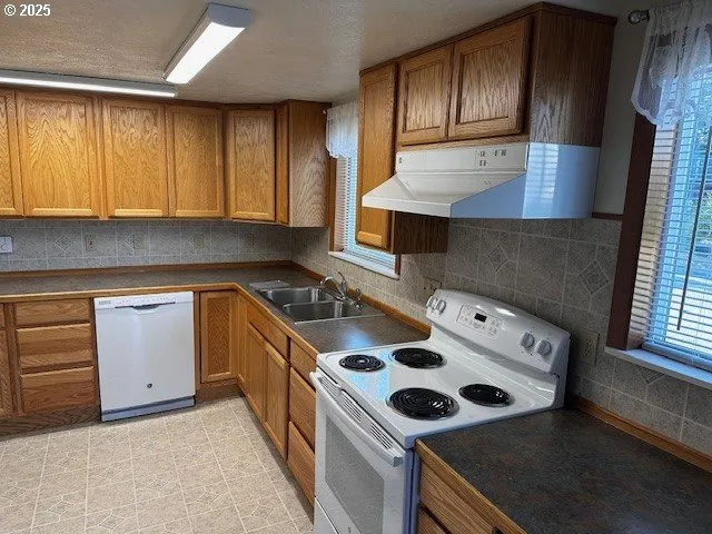 an empty room with a sink and a mirror