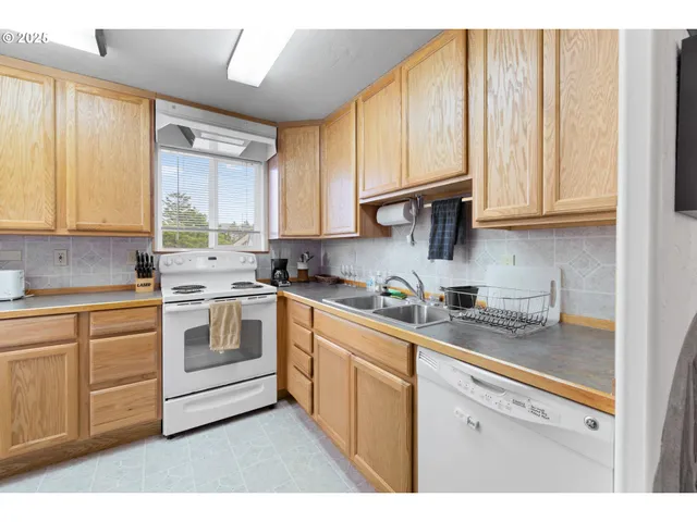 a kitchen with a refrigerator and white cabinets