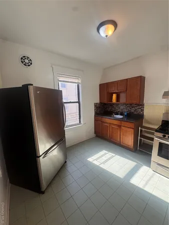a kitchen with stainless steel appliances a refrigerator and a stove top oven