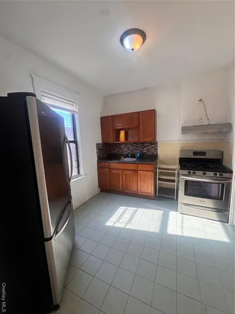a kitchen with stainless steel appliances granite countertop a refrigerator and a stove