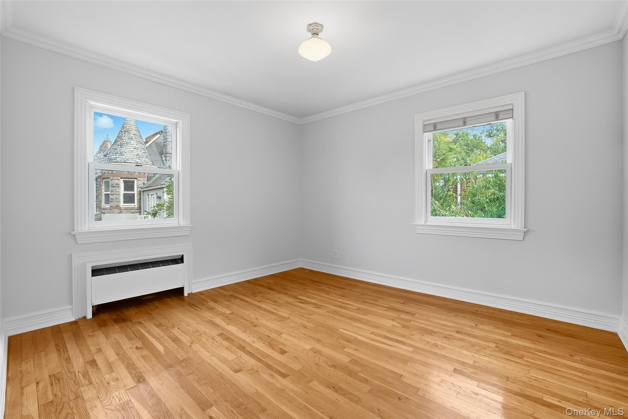 15 Chestnut Street, Unit A4 Rye, NY 10580 - Photo 12 of 14 a view of an empty room with a window and wooden floor