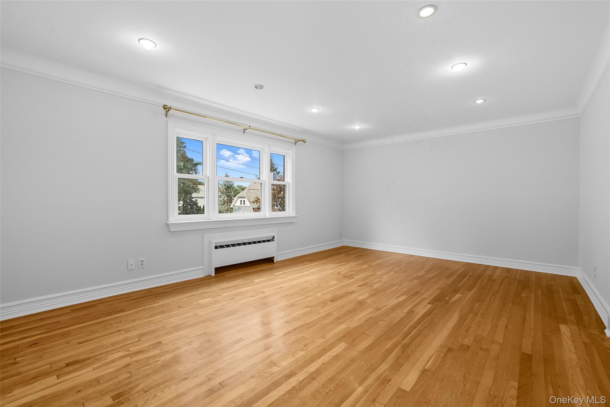 15 Chestnut Street, Unit A4 Rye, NY 10580 - Photo 4 of 14 a view of an empty room with wooden floor and a window