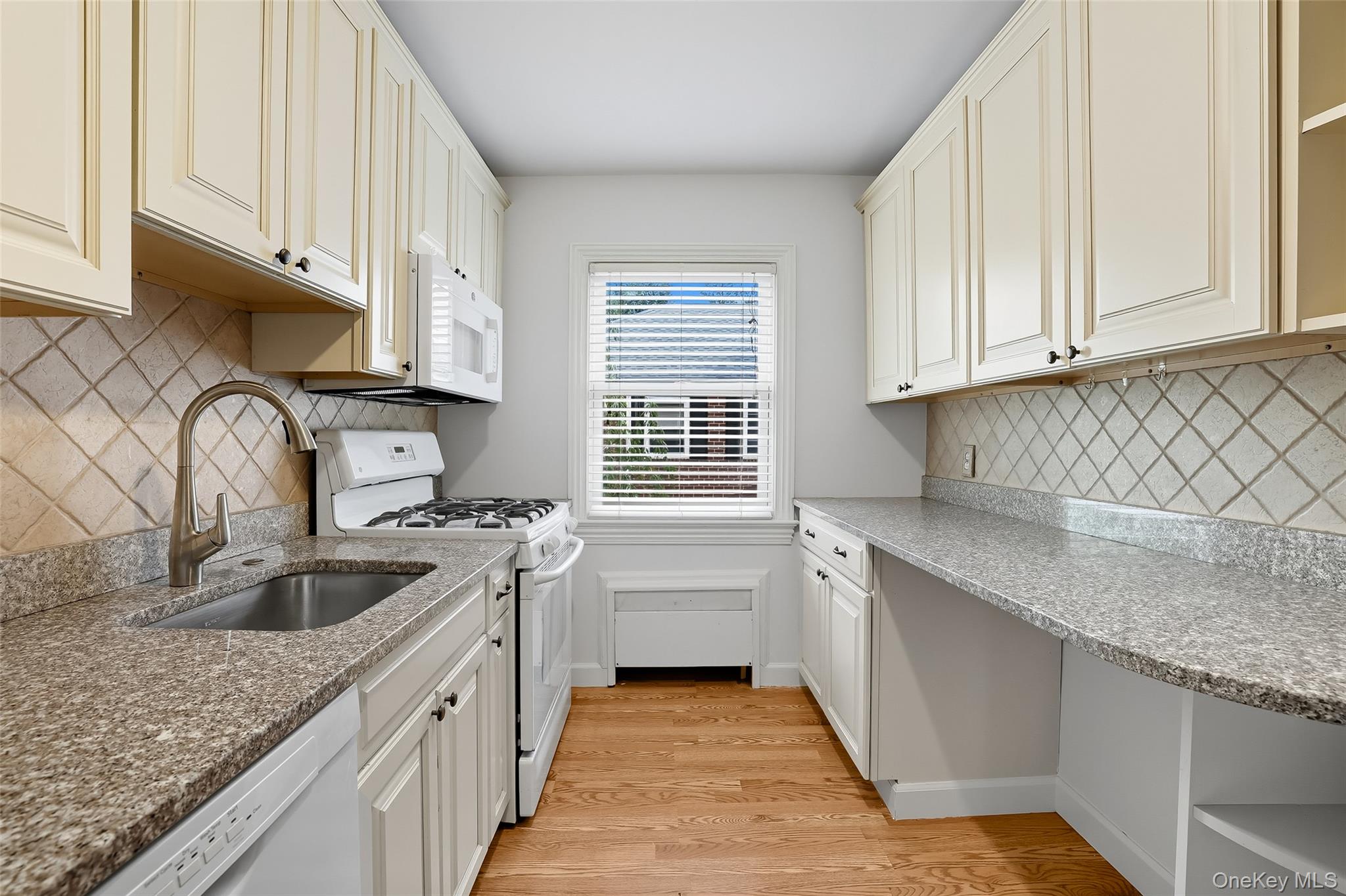 15 Chestnut Street, Unit A4 Rye, NY 10580 - Photo 6 of 14 a kitchen with granite countertop a sink stove and cabinets