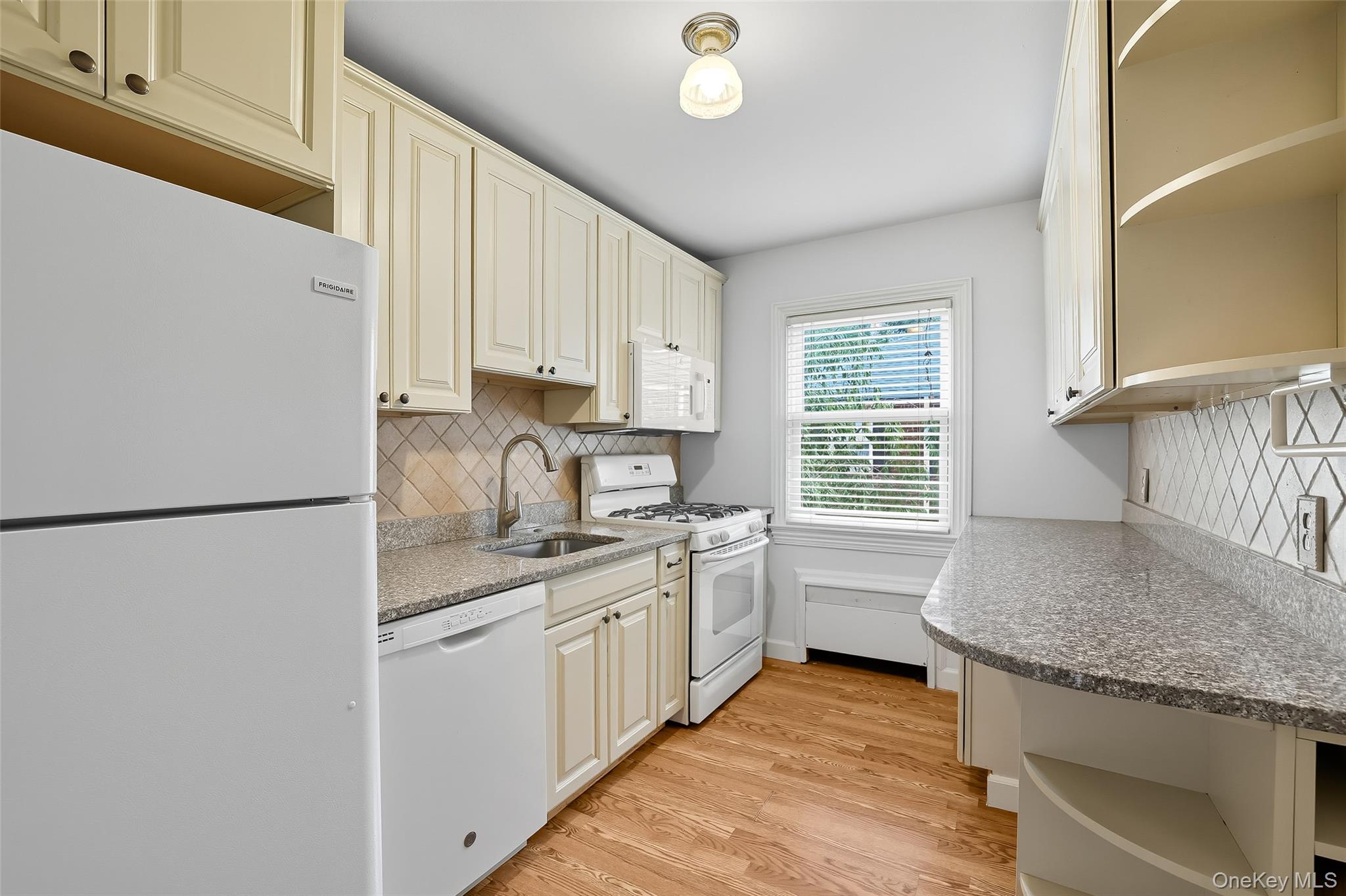 15 Chestnut Street, Unit A4 Rye, NY 10580 - Photo 7 of 14 a kitchen with stainless steel appliances granite countertop a sink stove and refrigerator