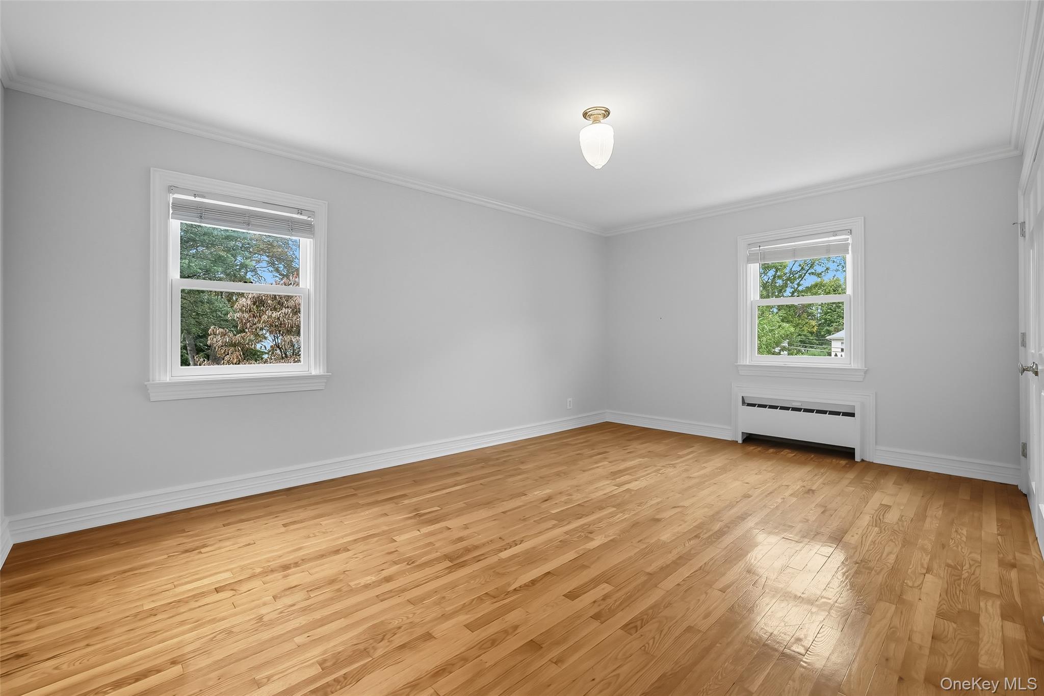 15 Chestnut Street, Unit A4 Rye, NY 10580 - Photo 9 of 14 a view of an empty room with wooden floor and a window