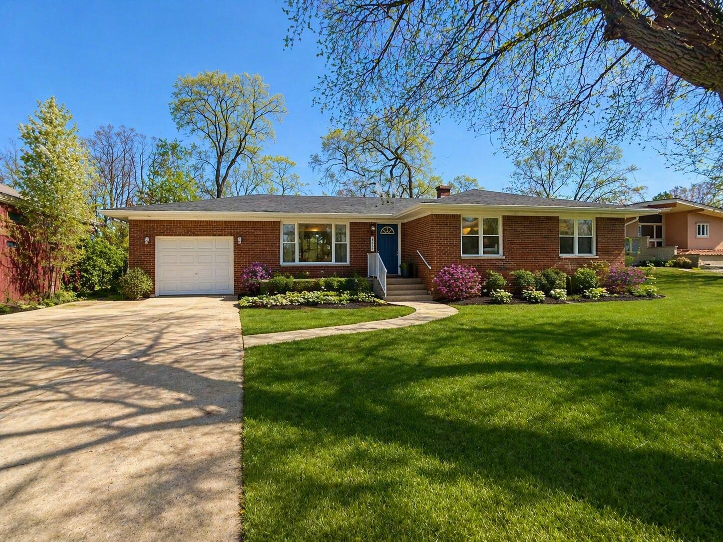 a front view of house with yard and green space