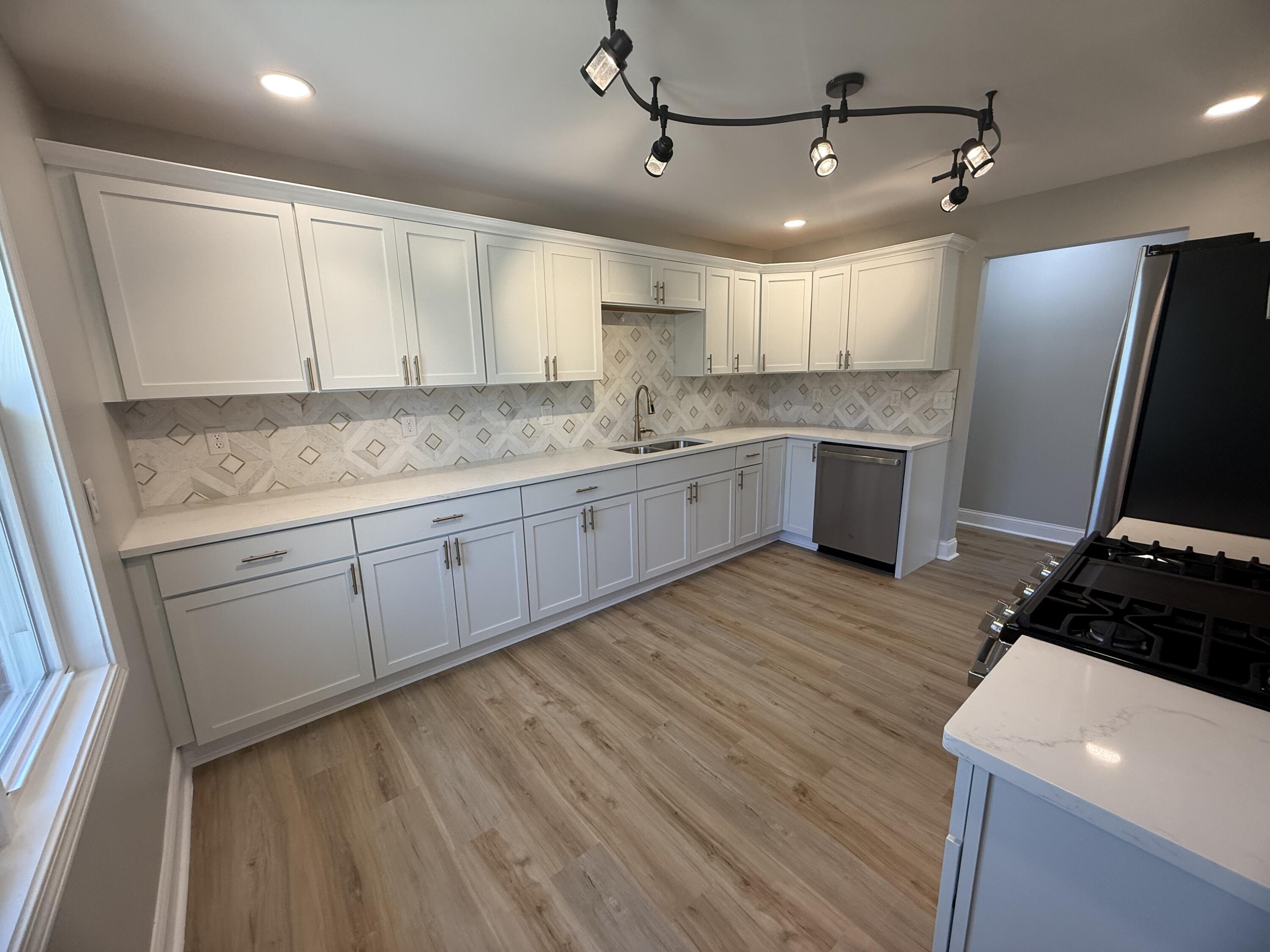 415 North Grand Boulevard Gary, IN 46403 - Photo 13 of 45 a kitchen with granite countertop a sink stainless steel appliances and cabinets