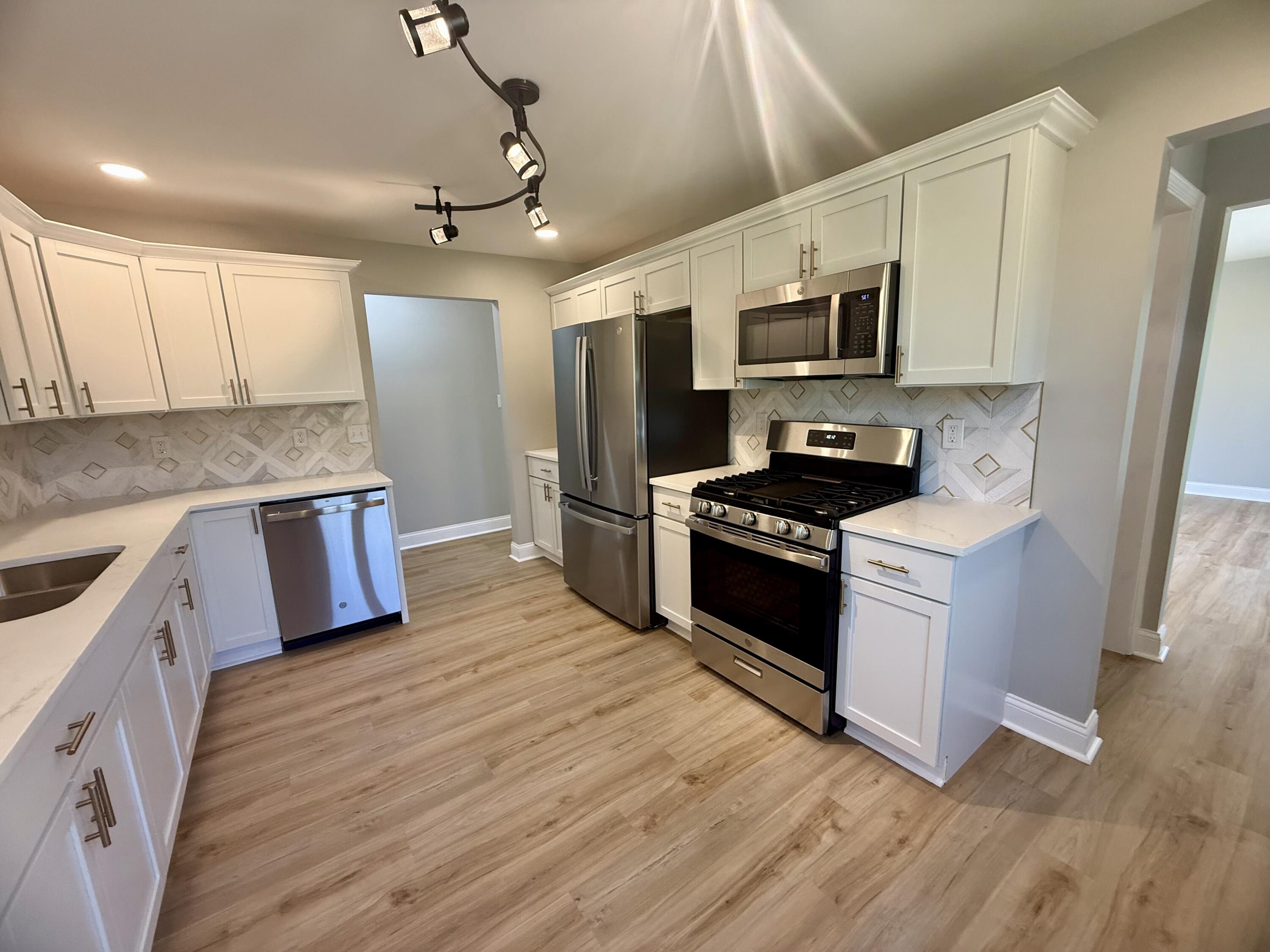 415 North Grand Boulevard Gary, IN 46403 - Photo 14 of 45 a kitchen with stainless steel appliances kitchen island granite countertop a stove a sink and a refrigerator
