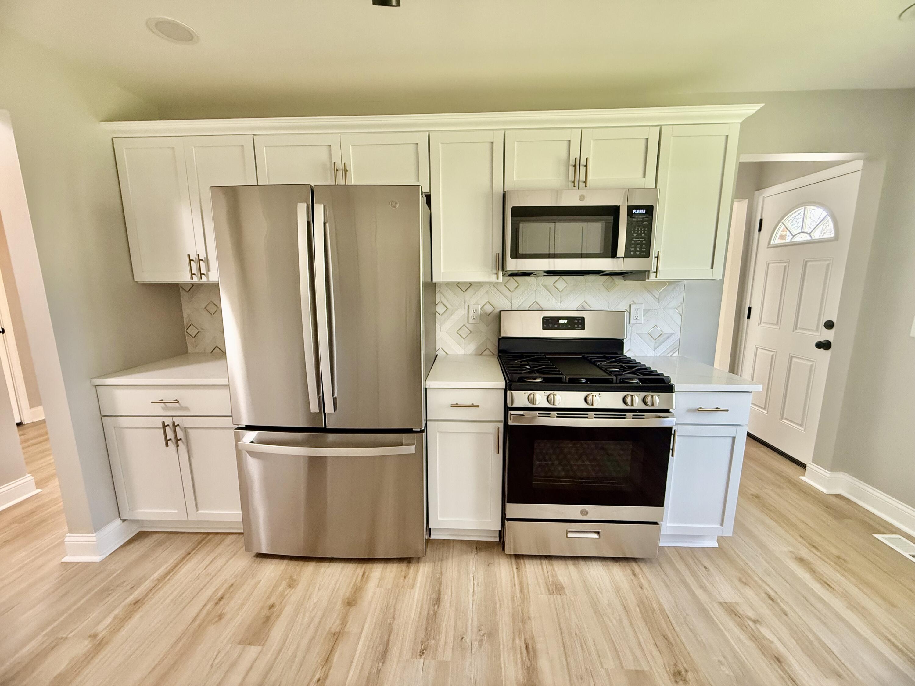 415 North Grand Boulevard Gary, IN 46403 - Photo 15 of 45 a kitchen with granite countertop a refrigerator and a stove