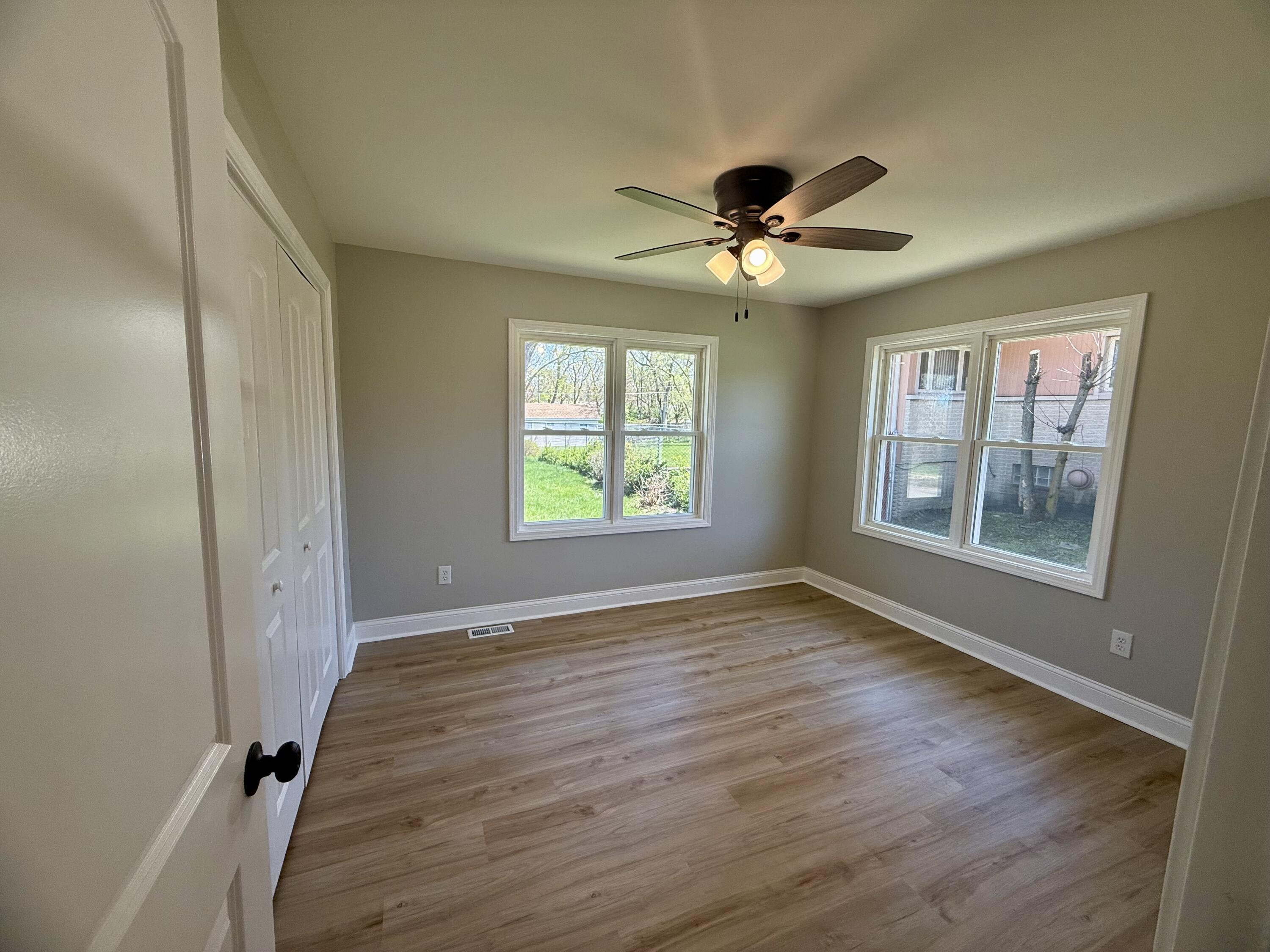 415 North Grand Boulevard Gary, IN 46403 - Photo 17 of 45 a view of an empty room with a window and wooden floor