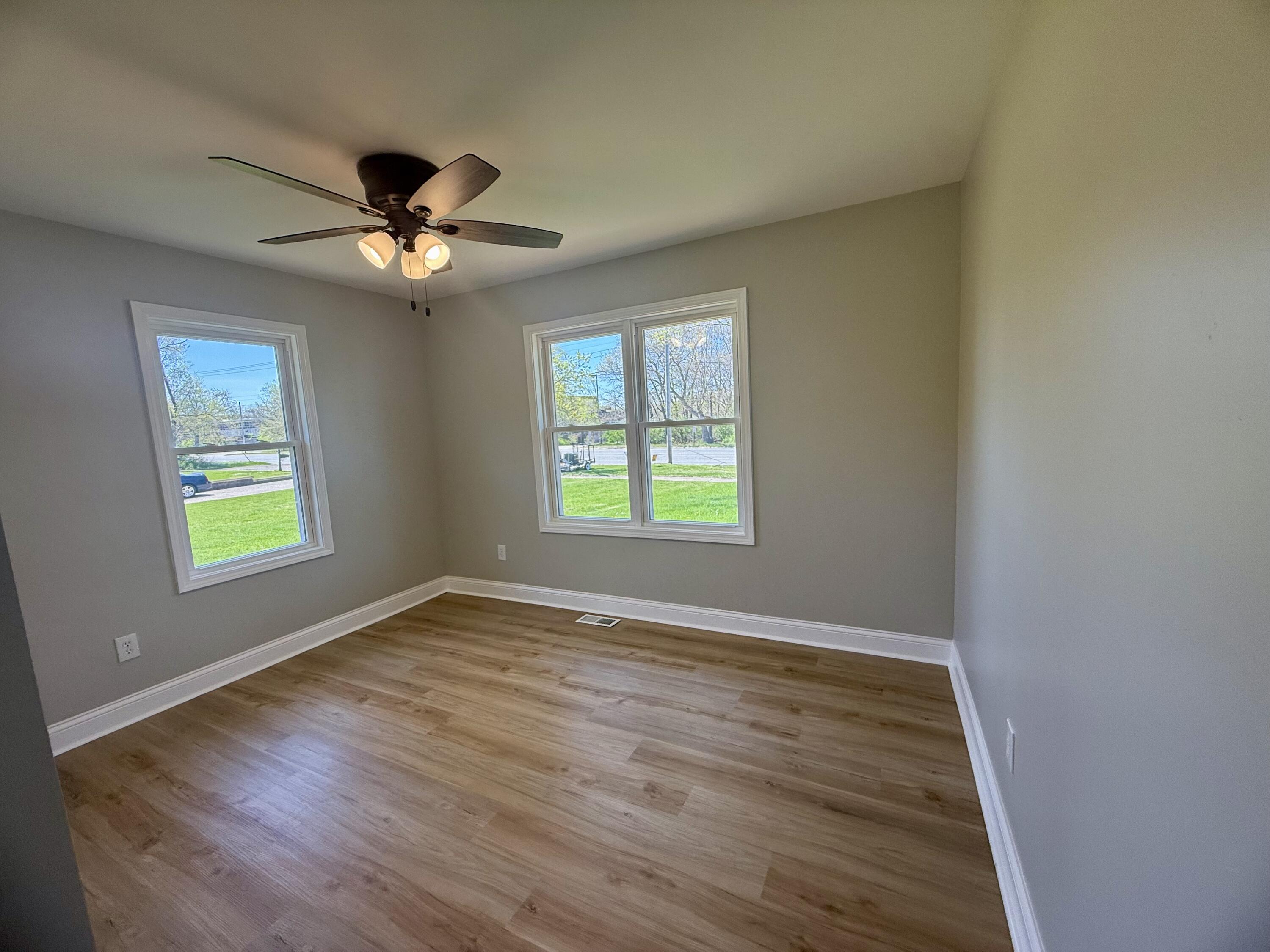 415 North Grand Boulevard Gary, IN 46403 - Photo 21 of 45 a view of an empty room with a window and wooden floor