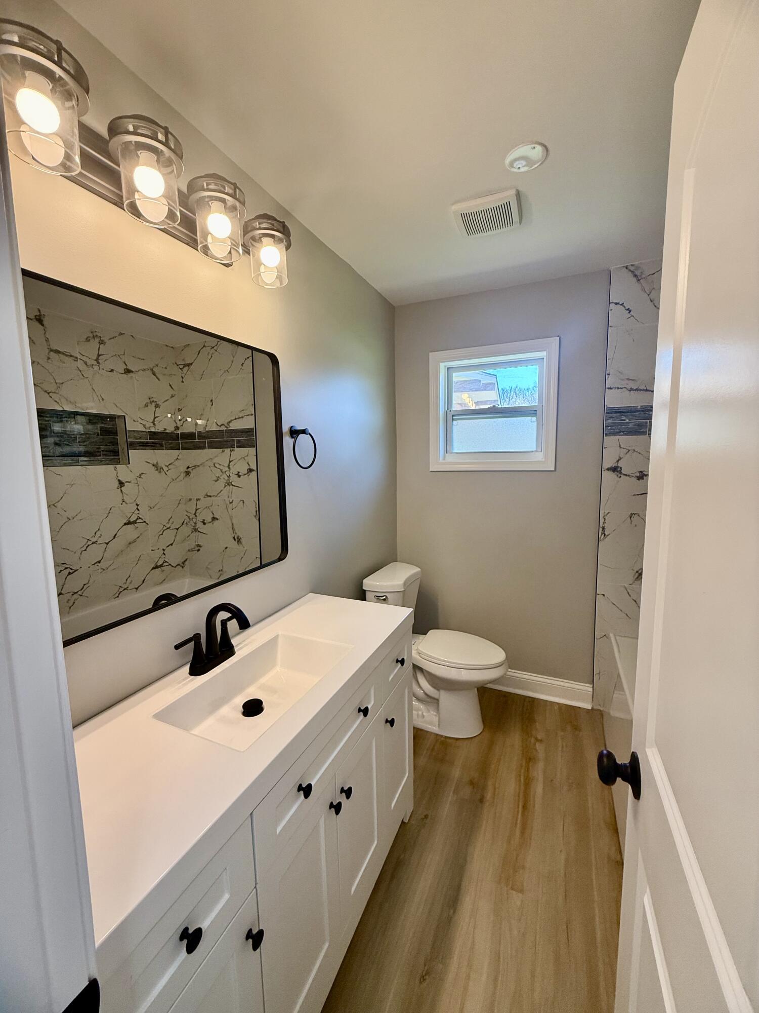 415 North Grand Boulevard Gary, IN 46403 - Photo 23 of 45 a bathroom with a sink a toilet and shower