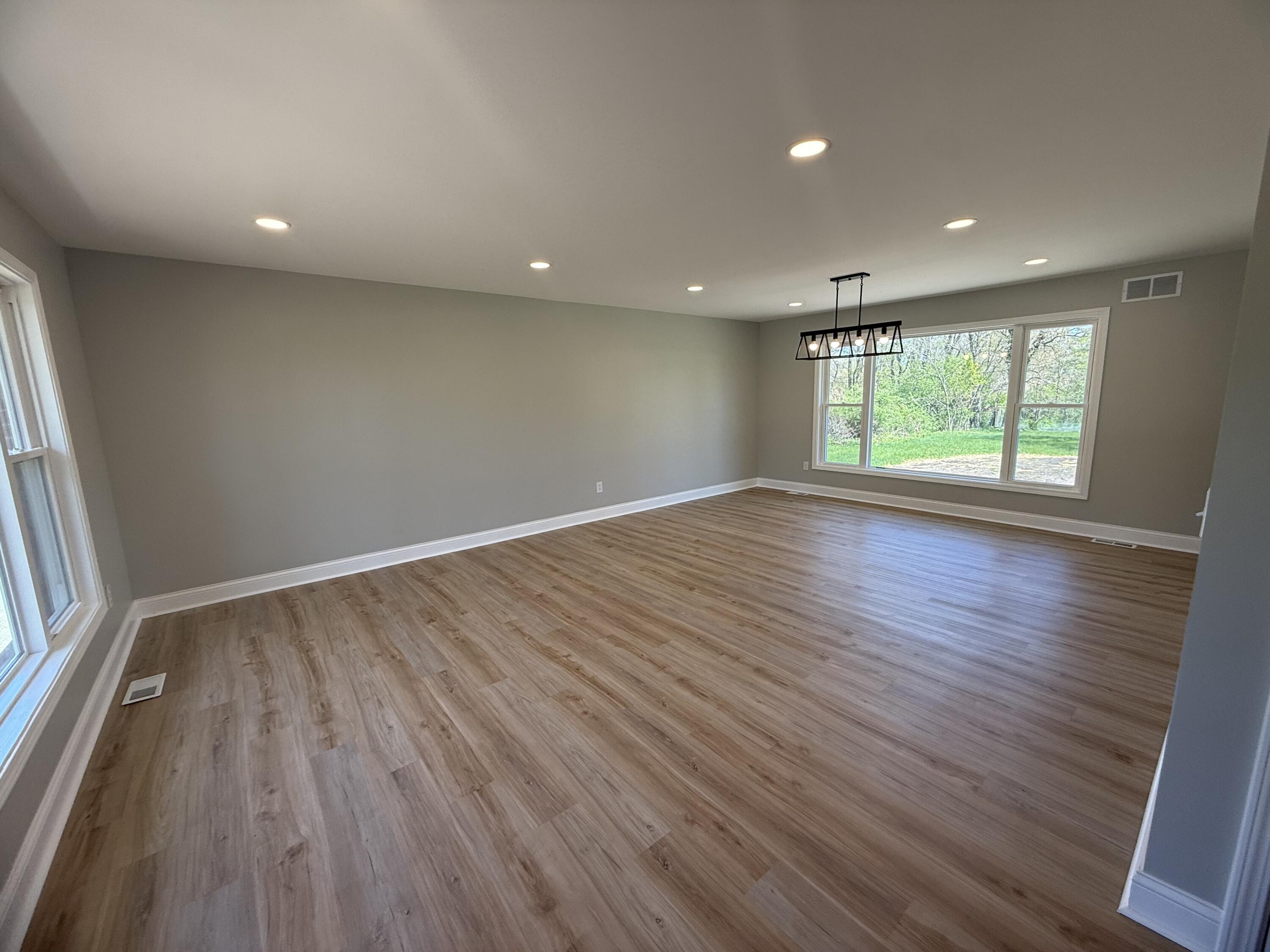 415 North Grand Boulevard Gary, IN 46403 - Photo 9 of 45 an empty room with wooden floor and windows