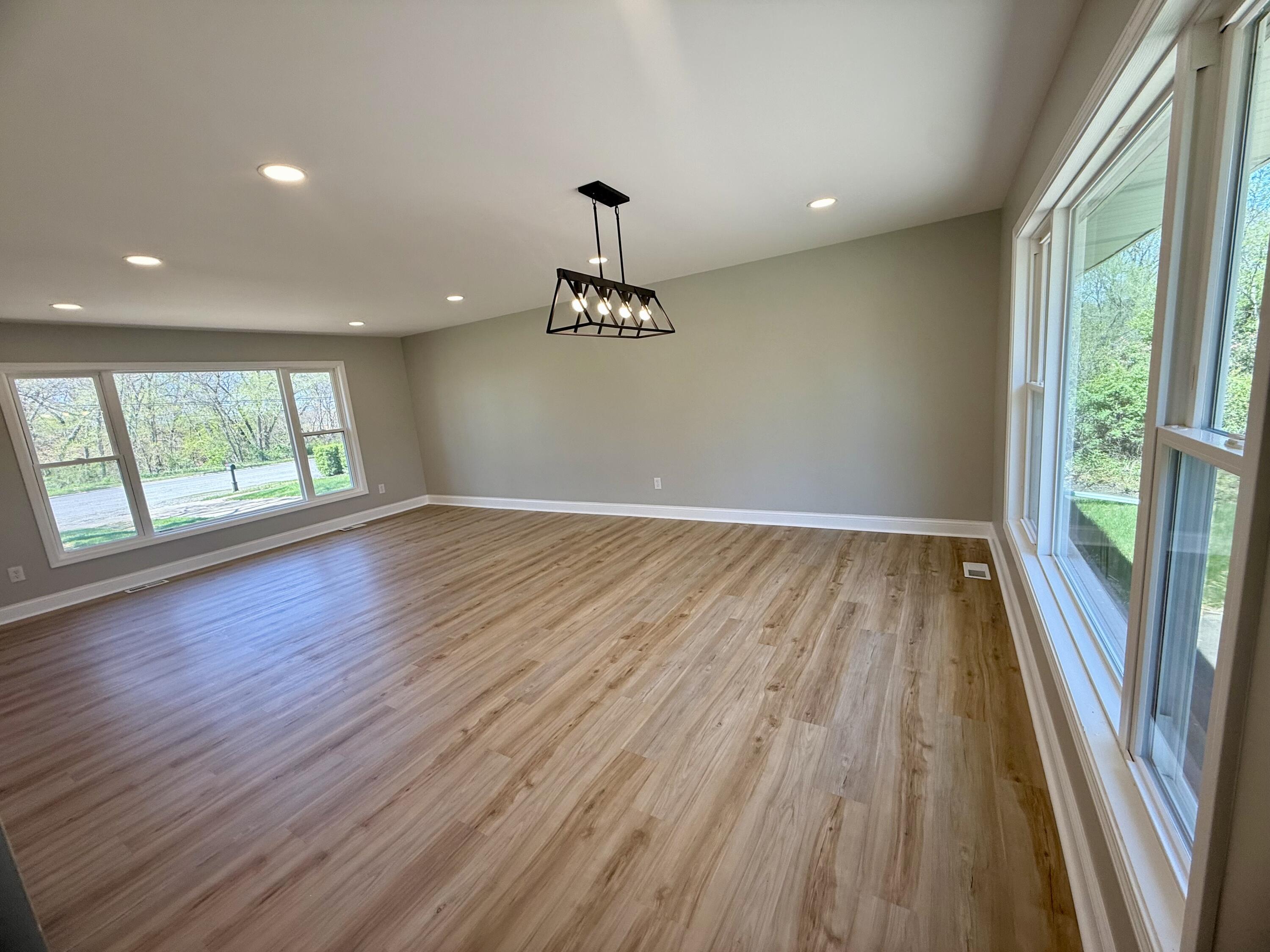 415 North Grand Boulevard Gary, IN 46403 - Photo 10 of 45 an empty room with wooden floor and windows