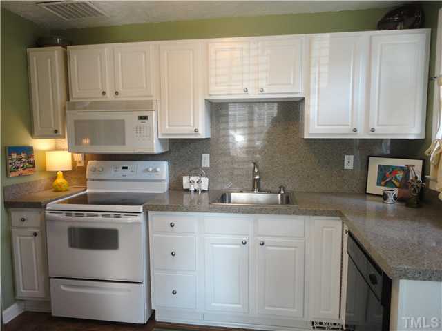 1206 Clifton Street Raleigh, NC 27604 - Photo 11 of 25 a kitchen with granite countertop white cabinets and white appliances