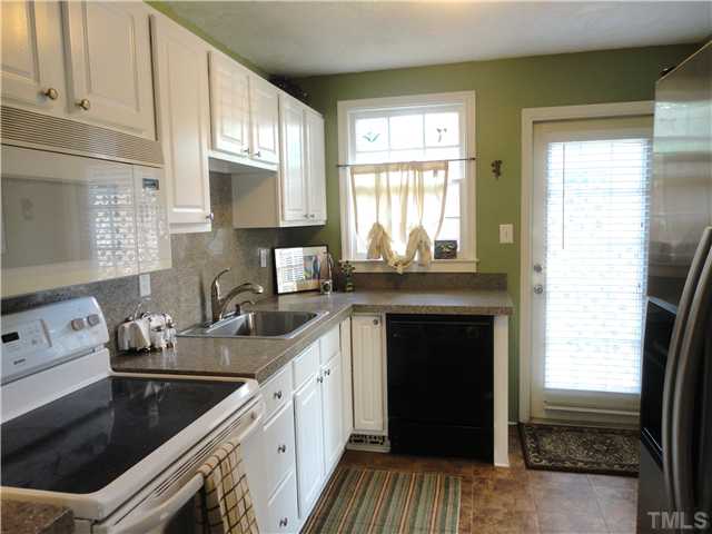 1206 Clifton Street Raleigh, NC 27604 - Photo 12 of 25 a kitchen with a sink stove and cabinets