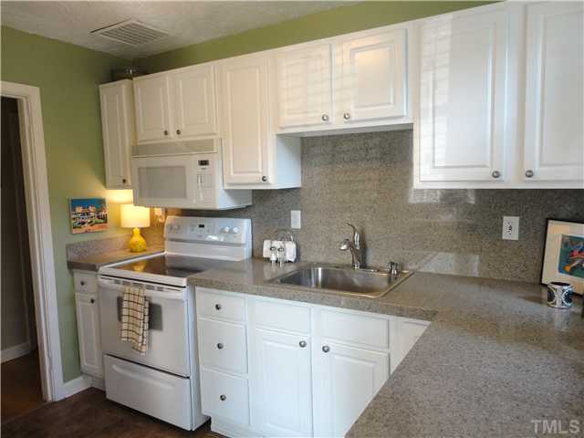 1206 Clifton Street Raleigh, NC 27604 - Photo 13 of 25 a kitchen with stainless steel appliances granite countertop a sink and cabinets