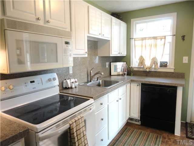 1206 Clifton Street Raleigh, NC 27604 - Photo 14 of 25 a kitchen with stainless steel appliances granite countertop a stove and a sink