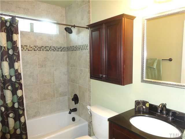1206 Clifton Street Raleigh, NC 27604 - Photo 17 of 25 a bathroom with a sink a toilet and shower