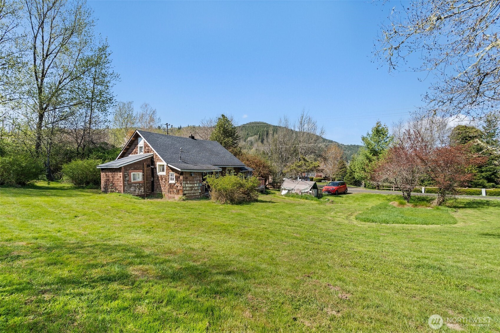 1234 Sherman Avenue Raymond, WA 98577 - Photo 3 of 8 a view of a big house with a big yard and large trees