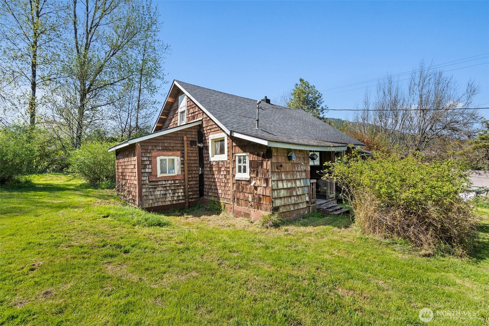 1234 Sherman Avenue Raymond, WA 98577 - Photo 4 of 8 a view of a house with a yard and sitting area