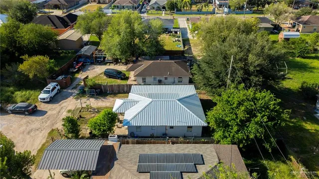 an aerial view of a house with a garden and lake view