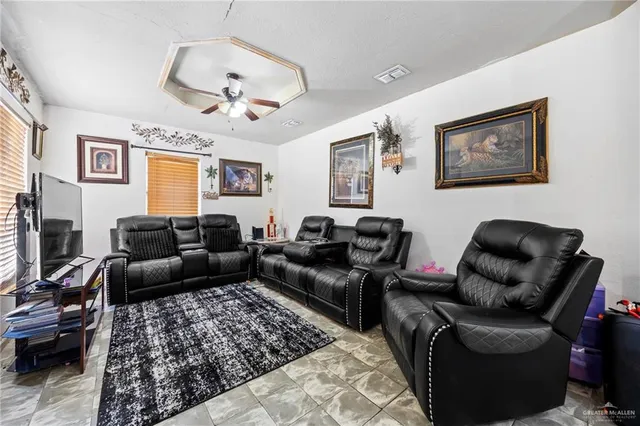 a living room with furniture or couch and a ceiling fan