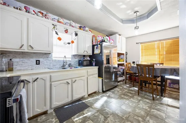 a kitchen with sink cabinets and window