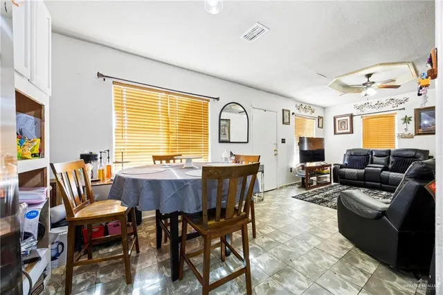 a view of a dining room with furniture and windows