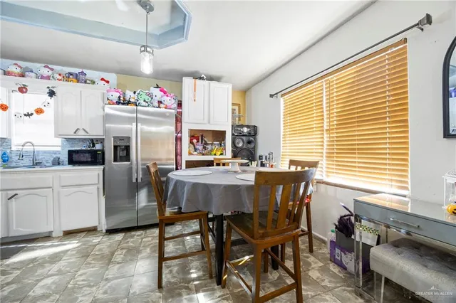 a dining room with furniture and window