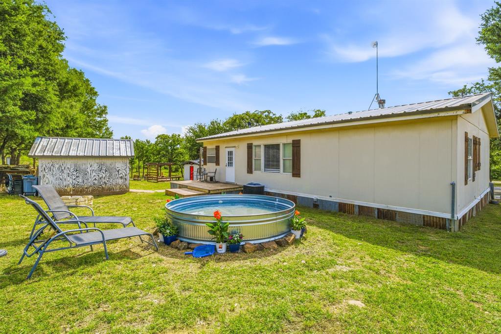 151 High Point Road Weatherford, TX 76088 - Photo 19 of 40 a view of a house with a backyard patio and swimming pool