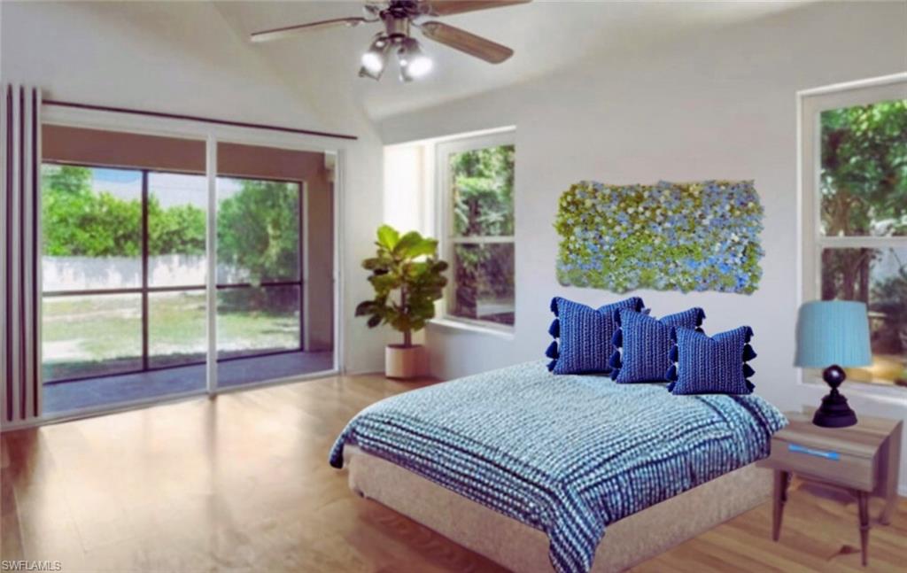 18355 Fuchsia Road Fort Myers, FL 33967 - Photo 3 of 13 a spacious bedroom with a large bed and a chandelier