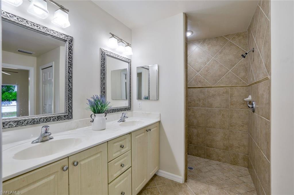 18355 Fuchsia Road Fort Myers, FL 33967 - Photo 5 of 13 a bathroom with a double vanity sink mirror and shower